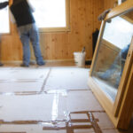 Workers installing new energy-efficient windows in a house