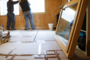 Workers installing new energy-efficient windows in a house